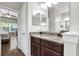 Bathroom with granite countertop vanity, large mirror, and stylish fixtures at 21028 Ski Way, Land O Lakes, FL 34638