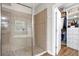 Walk-in shower with tile surround, next to organized walk-in closet at 21028 Ski Way, Land O Lakes, FL 34638