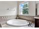 Bathroom featuring a soaking tub with decorative tile backsplash and accent molding at 21028 Ski Way, Land O Lakes, FL 34638