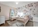 bedroom with floral wall art, two twin beds, and a window at 21028 Ski Way, Land O Lakes, FL 34638