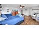 Bedroom features two beds, hardwood floor, television, and dresser with natural lighting at 21028 Ski Way, Land O Lakes, FL 34638