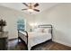 Bright bedroom features a metal frame bed, large window and a vintage-inspired rug at 21028 Ski Way, Land O Lakes, FL 34638