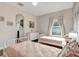 Bedroom with floral wallpaper, two twin beds, large window and neutral accents at 21028 Ski Way, Land O Lakes, FL 34638
