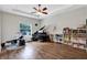Spacious bonus room featuring a grand piano, drum set, and built-in bookshelves at 21028 Ski Way, Land O Lakes, FL 34638