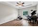 Bonus room with a trey ceiling, fan, piano and drum set at 21028 Ski Way, Land O Lakes, FL 34638