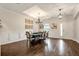 Elegant dining room featuring wood floors, tray ceiling, wainscoting, and modern lighting fixtures at 21028 Ski Way, Land O Lakes, FL 34638