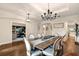 Open-concept dining area featuring hardwood floors, wainscoting, modern lighting, and views into the study at 21028 Ski Way, Land O Lakes, FL 34638