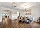 Elegant dining room featuring hardwood floors, wainscoting, tray ceiling, and stylish chandelier at 21028 Ski Way, Land O Lakes, FL 34638