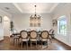 Bright dining room with wood floors, a decorative chandelier, and natural light from a window at 21028 Ski Way, Land O Lakes, FL 34638