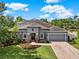Stunning home with a well-maintained lawn, stone accents, and an attached garage at 21028 Ski Way, Land O Lakes, FL 34638
