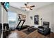 This residential gym features wood floors, a treadmill, ceiling fan, and a wall-mounted TV at 21028 Ski Way, Land O Lakes, FL 34638