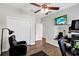 Residential gym with wood floor, ceiling fan, wall-mounted mirror, television, and a reclining chair at 21028 Ski Way, Land O Lakes, FL 34638