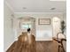 Inviting hallway with dark hardwood floors, arched doorways, and views into the living and dining areas at 21028 Ski Way, Land O Lakes, FL 34638