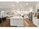 Bright kitchen features white cabinets, stainless steel appliances, large island and hardwood floors at 21028 Ski Way, Land O Lakes, FL 34638