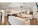 Open-concept living space featuring hardwood floors, modern lighting, and seamless flow to the kitchen and dining area at 21028 Ski Way, Land O Lakes, FL 34638