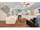 Comfortable living room features a fireplace, custom shelving, and hardwood floors at 21028 Ski Way, Land O Lakes, FL 34638