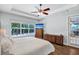 Bright main bedroom with ceiling fan, ample natural light, hardwood floors, and outside view at 21028 Ski Way, Land O Lakes, FL 34638