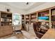 Home office with custom built-in bookshelves and a comfortable workspace at 21028 Ski Way, Land O Lakes, FL 34638
