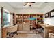 Well-lit home office featuring custom built-in shelving, a comfortable chair, and ample workspace at 21028 Ski Way, Land O Lakes, FL 34638