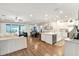 Bright, open-concept living space with hardwood floors connecting living, dining, and kitchen areas at 21028 Ski Way, Land O Lakes, FL 34638