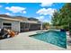 Relaxing backyard pool area with screened lanai, lounge chairs, and well-manicured landscaping at 21028 Ski Way, Land O Lakes, FL 34638
