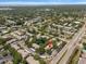 An aerial shot showcases a neighborhood with lush landscaping, community pool and tranquil pond at 2170 Elm St # 906, Dunedin, FL 34698