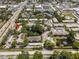 Aerial view of community featuring lush landscaping, pool, pond and covered parking at 2170 Elm St # 906, Dunedin, FL 34698