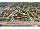 Bird's eye view of complex featuring a community pool, serene pond, and manicured landscaping at 2170 Elm St # 906, Dunedin, FL 34698