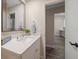 This updated bathroom features a modern vanity with quartz countertop and stylish mirror at 2170 Elm St # 906, Dunedin, FL 34698