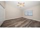 Bright bedroom with wood-look flooring, ceiling fan and a window at 2170 Elm St # 906, Dunedin, FL 34698