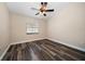 Bedroom featuring wood-look floors, neutral paint, a ceiling fan, and a window at 2170 Elm St # 906, Dunedin, FL 34698