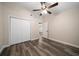 Bedroom featuring wood-look floors, neutral paint, a ceiling fan, and closet at 2170 Elm St # 906, Dunedin, FL 34698