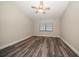 An empty bedroom with wood-look floors, a ceiling fan, and a window at 2170 Elm St # 906, Dunedin, FL 34698