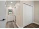 Hallway leading to an updated bathroom and hallway closet that offers modern fixtures at 2170 Elm St # 906, Dunedin, FL 34698