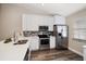 Well-equipped kitchen with stainless appliances, white cabinets, and quartz countertop at 2170 Elm St # 906, Dunedin, FL 34698