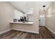 Inviting kitchen featuring modern appliances, white cabinetry, and stylish countertop bar at 2170 Elm St # 906, Dunedin, FL 34698