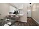 Open kitchen featuring a breakfast bar, new appliances, and a modern backsplash at 2170 Elm St # 906, Dunedin, FL 34698