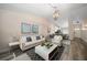 Bright living room with hardwood floors, neutral walls, and modern furniture at 2170 Elm St # 906, Dunedin, FL 34698