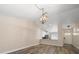 Open concept living room showcases modern lighting and transitions into the kitchen area at 2170 Elm St # 906, Dunedin, FL 34698