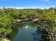 Scenic view of a tranquil pond with a fountain, surrounded by lush trees at 2170 Elm St # 906, Dunedin, FL 34698