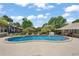 Community pool with lounge chairs surrounded by lush landscaping at 2170 Elm St # 906, Dunedin, FL 34698