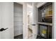 Home features ample storage space with shelving and a utility closet with water heater at 2170 Elm St # 906, Dunedin, FL 34698