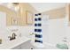 Cozy bathroom features modern vanity and white subway tiled shower at 219 80Th Ne Ave, St Petersburg, FL 33702