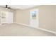 Bright bedroom with a ceiling fan, white trim and a closet and backyard access at 219 80Th Ne Ave, St Petersburg, FL 33702