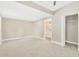 Spacious bedroom with neutral carpet, closet, and bathroom entrance at 219 80Th Ne Ave, St Petersburg, FL 33702
