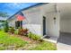 Inviting exterior view showcasing a blue front door, a covered entryway, and beautiful landscaping at 219 80Th Ne Ave, St Petersburg, FL 33702