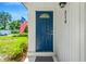 This property's blue front door with a decorative window offers a secure and stylish welcome at 219 80Th Ne Ave, St Petersburg, FL 33702