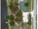 An aerial view shows a basketball court, playground, lake access, and parking within this community at 2324 Hayworth Rd, Port Charlotte, FL 33952
