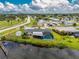 Aerial view of the home and screened in pool on a corner lot near the water at 2324 Hayworth Rd, Port Charlotte, FL 33952