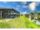 Landscaped backyard features a screened-in patio with scenic waterfront views at 2324 Hayworth Rd, Port Charlotte, FL 33952